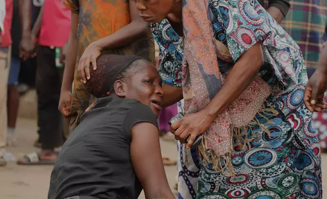 FILE - Women mourn the death of a family member following an attack by gunmen in Gari Ya Waye community in Jos North Nigeria, March 30, 2026. (AP Photo/Samson Omale, File)
