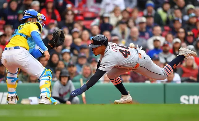 Detroit Tigers' Wenceel Pérez (46) scores on a sacrifice fly by Jake Rogers as Boston Red Sox catcher Connor Wong, left, waits for the ball in the fourth inning of a baseball game, Saturday, April 18, 2026, in Boston. (AP Photo/Steven Senne)