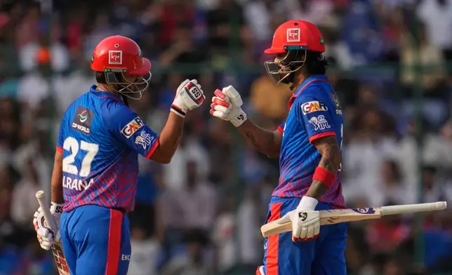 Delhi Capitals' KL Rahul, left, and batting partner Nitish Rana touch gloves during the Indian Premier League cricket match between Delhi Capitals and Punjab Kings in New Delhi, India, Saturday, April 25, 2026. (AP Photo/Manish Swarup)