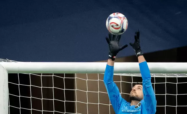 Portland Timbers goalkeeper James Pantemis (41) stops the ball against the Vancouver Whitecaps during the first half of an MLS soccer match in Vancouver, British Columbia, on Saturday, April 4, 2026. (Ethan Cairns/The Canadian Press via AP)