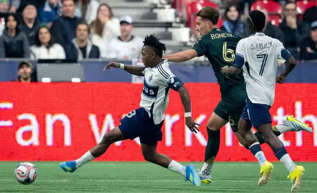 Vancouver Whitecaps' Edier Ocampo (18) scores as teammate Cheikh Sabaly (7) and Portland Timbers' Alex Bonetig (6) watch during the first half of an MLS soccer match in Vancouver, British Columbia, on Saturday, April 4, 2026. (Ethan Cairns/The Canadian Press via AP)