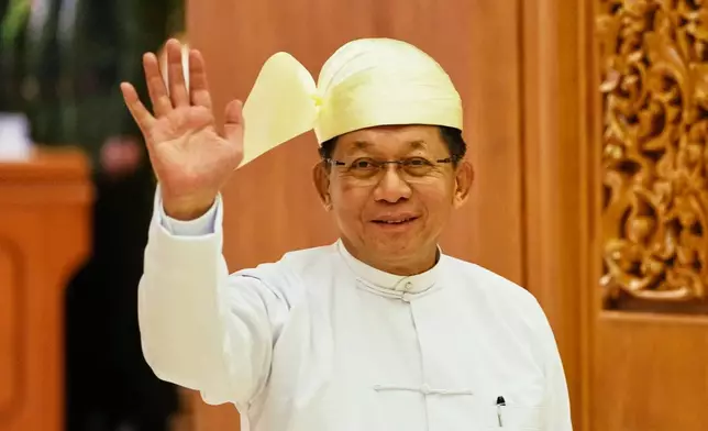 Myanmar newly elected President Min Aung Hlaing waves as he leaves Union parliament after a sworn-in ceremony in Naypyitaw, Myanmar, Friday, April 10, 2026. (AP Photo/Aung Shine Oo)