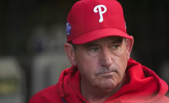Philadelphia Phillies manager Rob Thomson (49) stands in the dugout before a baseball game against the Chicago Cubs, Wednesday, April 22, 2026, in Chicago. (AP Photo/Erin Hooley)