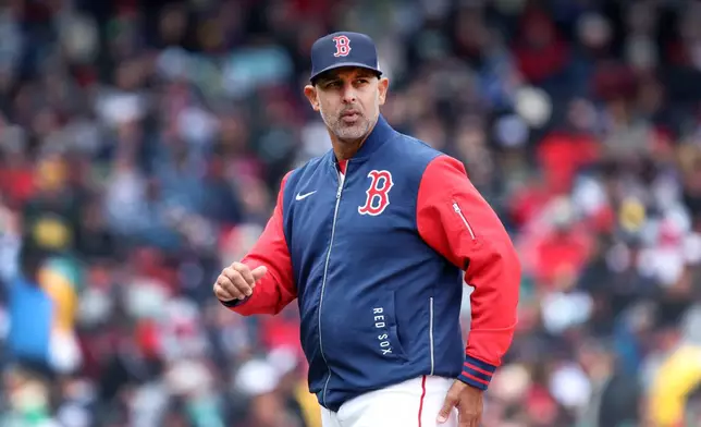 Boston Red Sox' manager Alex Cora walks back to the dugout after a mound visit during a baseball game against the Detroit Tigers, Monday, April 20, 2026, in Boston. (AP Photo/Jim Davis)