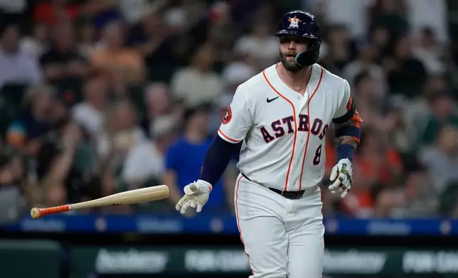 Houston Astros' Christian Walker tosses his bat after hitting a solo home run during the second inning of a baseball game against the Colorado Rockies, Tuesday, April 14, 2026, in Houston. (AP Photo/Kevin M. Cox)