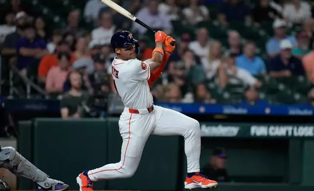 Houston Astros' Cam Smith hits an RBI single during the third inning of a baseball game against the Colorado Rockies, Tuesday, April 14, 2026, in Houston. (AP Photo/Kevin M. Cox)