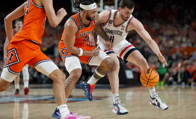 Illinois guard Kylan Boswell (4) and UConn forward Alex Karaban (11) battle for the ball during the first half of an NCAA college basketball tournament semifinal game at the Final Four, Saturday, April 4, 2026, in Indianapolis. (AP Photo/Abbie Parr)