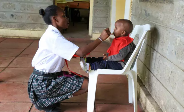Mary Wanjiku, 20 feeds her son Stephan Keyllin during lunchtime at Greenland Girls School in Kiserian, Kajiado, Kenya, March 5, 2026. (AP Photo/Andrew Kasuku)