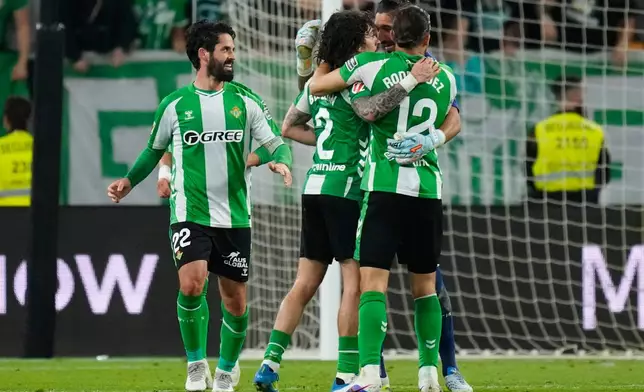 Real Betis players celebrate after scoring during a La Liga soccer match between Real Betis and Real Madrid in Seville, Spain, Friday, April 24, 2026. (AP Photo/Jose Breton)