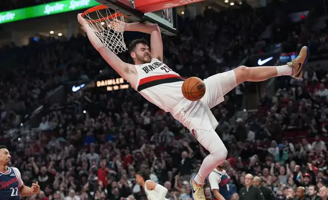 Portland Trail Blazers center Donovan Clingan dunks during the first half of an NBA basketball game against the Los Angeles Clippers, Friday, April 10, 2026, in Portland, Ore. (AP Photo/Jenny Kane)