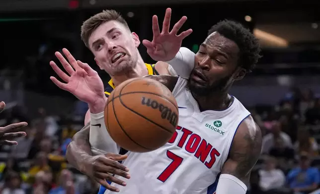 Indiana Pacers center Micah Potter (11) goes over the back of Detroit Pistons forward Paul Reed (7) during the second half of an NBA basketball game in Indianapolis, Sunday, April 12, 2026. (AP Photo/Michael Conroy)