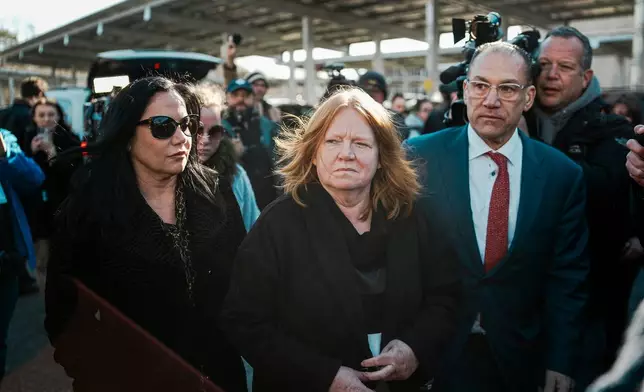 Asa Ellerup, left, wife, of Rex Heuermann and Ellerup's attorney, Robert Macedonio, right arrive outside court as Rex Heuermann, accused in Long Island's infamous Gilgo Beach serial killings, is expected to plead guilty, Wednesday, April 8, 2026, at Suffolk County Court in Riverhead, N.Y. (AP Photo/Eduardo Munoz Alvarez)