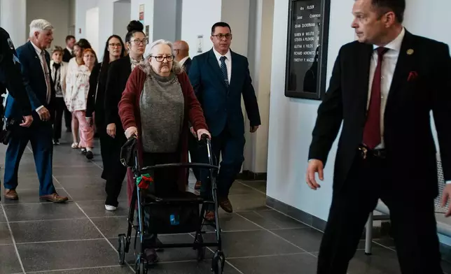 Elizabeth Baczkiel, mother of victim Jessica Taylor, walks to the courtroom as Rex Heuermann, accused in Long Island's infamous Gilgo Beach serial killings, is expected to plead guilty, Wednesday, April 8, 2026, at Suffolk County Court in Riverhead, N.Y. (AP Photo/Eduardo Munoz Alvarez)