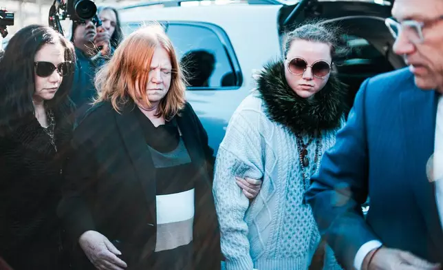Asa Ellerup, estranged wife, center left, and her daughter Victoria Heuermann arrive outside court as Rex Heuermann, accused in Long Island’s infamous Gilgo Beach serial killings, is expected to plead guilty, Wednesday, April 8, 2026, at Suffolk County Court in Riverhead, N.Y. (AP Photo/Eduardo Munoz Alvarez)
