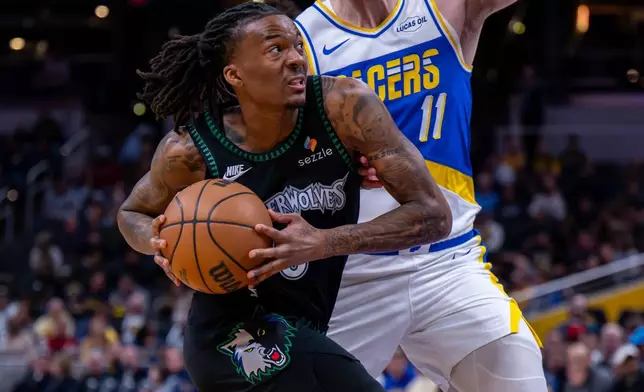 Minnesota Timberwolves guard Bones Hyland drives to the basket during the first half of an NBA basketball game against the Indiana Pacers in Indianapolis, Tuesday, April 7, 2026. (AP Photo/Doug McSchooler)