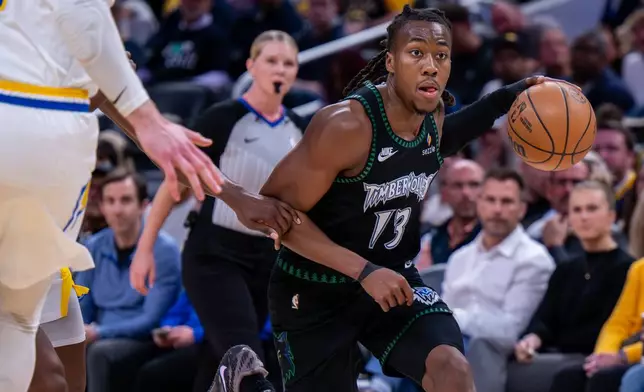 Minnesota Timberwolves guard Ayo Dosunmu (13) drives toward the basket during the first half of an NBA basketball game against the Indiana Pacers in Indianapolis, Tuesday, April 7, 2026. (AP Photo/Doug McSchooler)