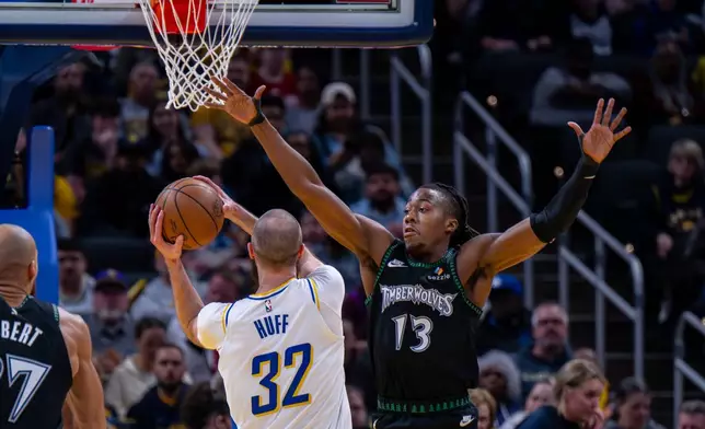 Minnesota Timberwolves guard Ayo Dosunmu (13) reaches for a shot attempt by Indiana Pacers center Jay Huff (32) during the first half of an NBA basketball game in Indianapolis, Tuesday, April 7, 2026. (AP Photo/Doug McSchooler)