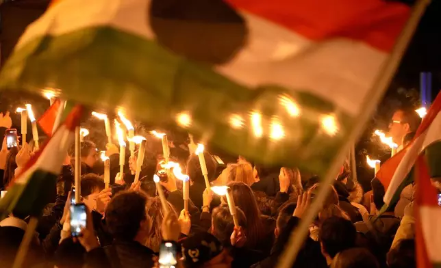 Supporters of Peter Magyar, the leader of the opposition Tisza party celebrate after a parliamentary election in Budapest, Hungary, Sunday, April 12, 2026. (AP Photo/Darko Bandic)