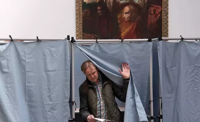 A man prepares to cast his ballot at a polling station in Budapest, Hungary, Sunday, April 12, 2026. (AP Photo/Petr David Josek)