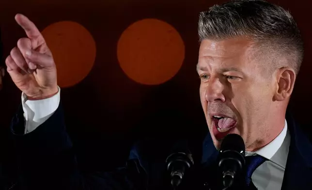 Peter Magyar, the leader of the opposition Tisza party addresses after claiming victory in a parliamentary election in Budapest, Hungary, Sunday, April 12, 2026. (AP Photo/Darko Bandic)