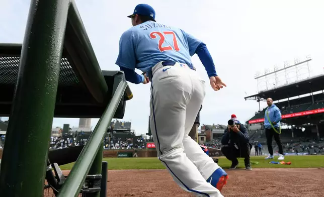Chicago Cubs' Seiya Suzuki runs onto the field from the dugout before a baseball game against the Pittsburgh Pirates in Chicago, Friday, April 10, 2026. (AP Photo/Paul Beaty)