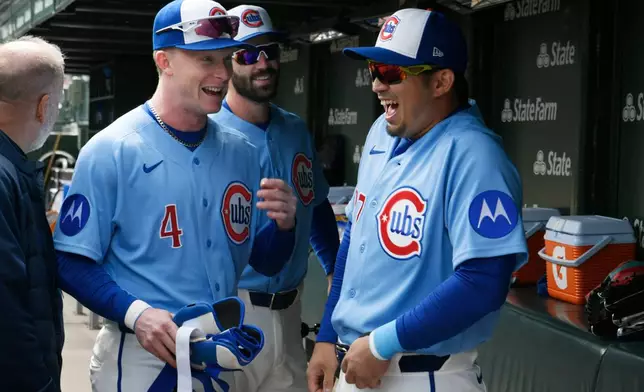 Chicago Cubs' Seiya Suzuki, right, jokes around with teammate Pete Crow-Armstrong (4) in the dugout before a baseball game against the Pittsburgh Pirates in Chicago, Friday, April 10, 2026. (AP Photo/Paul Beaty)