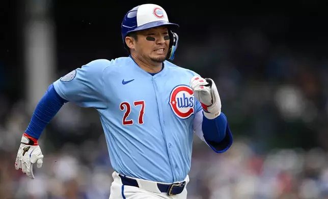 Chicago Cubs' Seiya Suzuki (27) runs to first base during the second inning of a baseball game against the Pittsburgh Pirates in Chicago, Friday, April 10, 2026. (AP Photo/Paul Beaty)