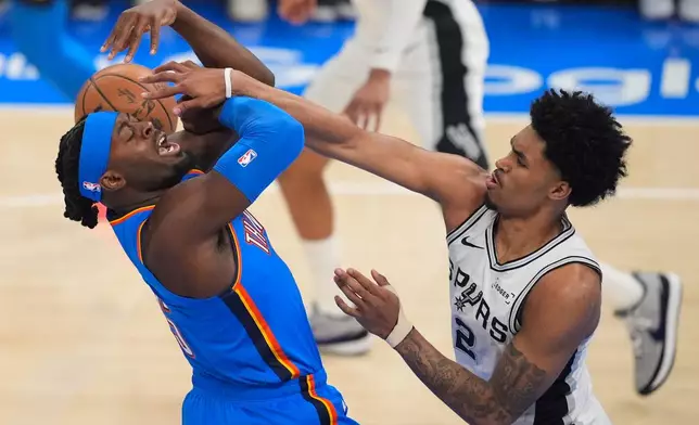 San Antonio Spurs guard Dylan Harper (2) defends against Oklahoma City Thunder guard Luguentz Dort (5) during the first half of Game 2 in the Western Conference finals NBA basketball playoffs series Wednesday, May 20, 2026, in Oklahoma City. (AP Photo/Tony Gutierrez)