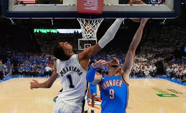 San Antonio Spurs forward Victor Wembanyama (1) blocks a shot by Oklahoma City Thunder guard Alex Caruso (9) during the second half of Game 2 in the Western Conference finals NBA basketball playoffs series Wednesday, May 20, 2026, in Oklahoma City. (AP Photo/Nate Billings)
