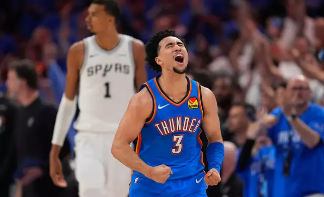 Oklahoma City Thunder guard Jared McCain (3) celebrates after making a 3-pointer during the second half of Game 2 in the Western Conference finals NBA basketball playoffs series against the San Antonio Spurs Wednesday, May 20, 2026, in Oklahoma City. (AP Photo/Tony Gutierrez)