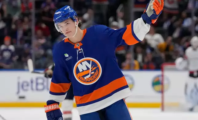 FILE - New York Islanders' Matthew Schaefer (48) celebrates after a goal he scored was reviewed during the third period of an NHL hockey game against the Washington Capitals, Oct. 11, 2025, in Elmont, N.Y. (AP Photo/Frank Franklin II, file)