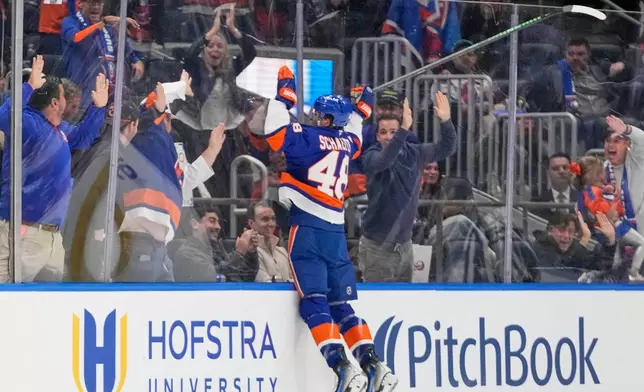 FILE - New York Islanders' Matthew Schaefer (48) celebrates after scoring his first NHL goal during the third period of an NHL hockey game against the Washington Capitals, Oct. 11, 2025, in Elmont, N.Y. (AP Photo/Frank Franklin II, file)