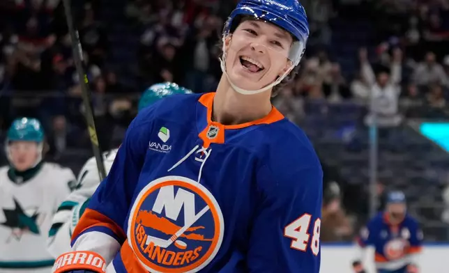 FILE - New York Islanders' Matthew Schaefer (48) smiles after scoring a goal during the second period of an NHL hockey game against the San Jose Sharks, Oct. 21, 2025, at UBS Arena in Elmont, N.Y. (AP Photo/Frank Franklin II, file)
