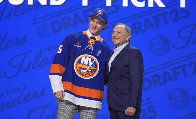FILE - Matthew Schaefer, left, stands with NHL commissioner Gary Bettman after being drafted by the New York Islanders during the NHL hockey draft Friday, June 27, 2025, in Los Angeles. (AP Photo/Damian Dovarganes, File)