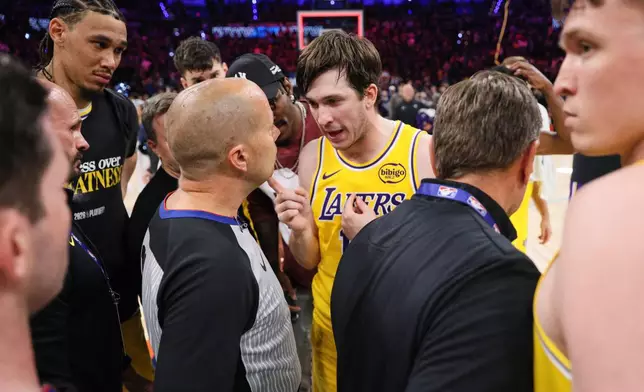 Los Angeles Lakers' Austin Reaves, center right, talks with referee John Goble, center, left, after the team's loss in Game 2 in a second-round NBA basketball playoffs series against the Oklahoma City Thunder Thursday, May 7, 2026, in Oklahoma City. (AP Photo/Nate Billings)