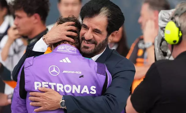 Mohammed Ben Sulayem President of the Federation Internationale de l'Automobile (FIA) hugs Mercedes driver Kimi Antonelli of Italy after Antonelli won the Miami Formula One Grand Prix auto race, Sunday, May 3, 2026, in Miami Gardens, Fla. (AP Photo/Rebecca Blackwell)