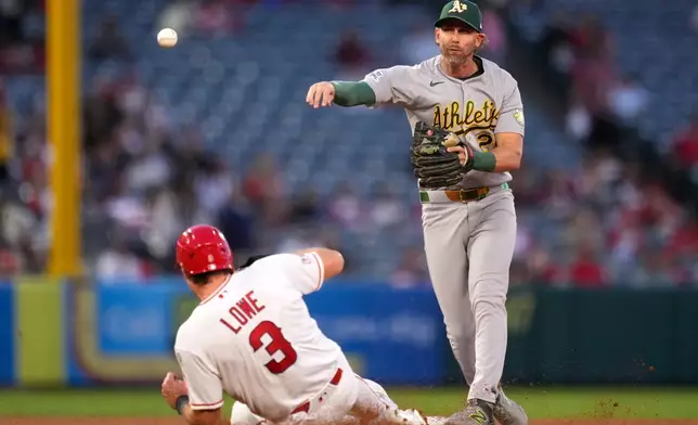 Los Angeles Angels' Josh Lowe, left, is forced out at second as Athletics second baseman Jeff McNeil throws out Jose Siri at first during the fifth inning of a baseball game Thursday, May 21, 2026, in Anaheim, Calif. (AP Photo/Mark J. Terrill)