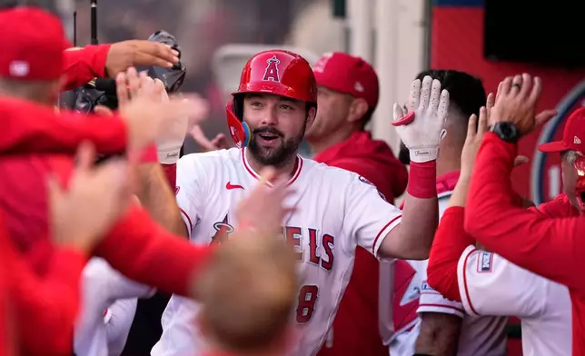 Los Angeles Angels' Nolan Schanuel is congratulated by teammates in the dugout after hitting a two-run home run during the first inning of a baseball game against the Athletics, Thursday, May 21, 2026, in Anaheim, Calif. (AP Photo/Mark J. Terrill)