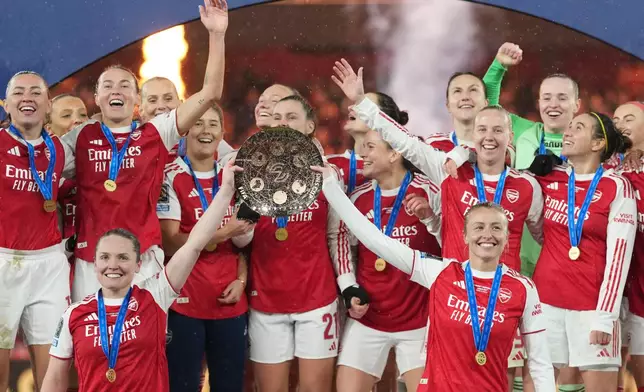 FILE - Arsenal's team captains Kin Little, left, and Leah Williamson, right, lift the trophy after winning the Women's Champions Cup final soccer match between Arsenal FC and SC Corinthians in London, Sunday, Feb. 1, 2026. (AP Photo/Alastair Grant, File)