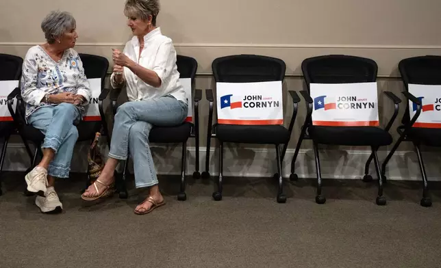 Darlee Foster, left, and Debbie King talk before the Sen. John Cornyn, R-Texas, campaign event in Lubbock, Texas, Tuesday, May 19, 2026. (AP Photo/Annie Rice)