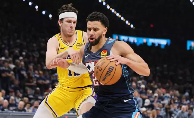 Oklahoma City Thunder guard Ajay Mitchell, front, works for a shot as Los Angeles Lakers' Austin Reaves, rear, defends in the second half of Game 2 in a second-round NBA basketball playoffs series Thursday, May 7, 2026, in Oklahoma City. (AP Photo/Nate Billings)