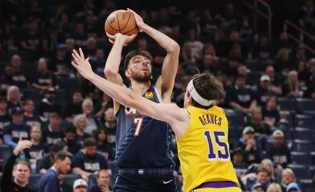 Oklahoma City Thunder's Chet Holmgren (7) shoots over Los Angeles Lakers' Austin Reaves (15) in the second half of Game 2 in a second-round NBA basketball playoffs series Thursday, May 7, 2026, in Oklahoma City. (AP Photo/Nate Billings)