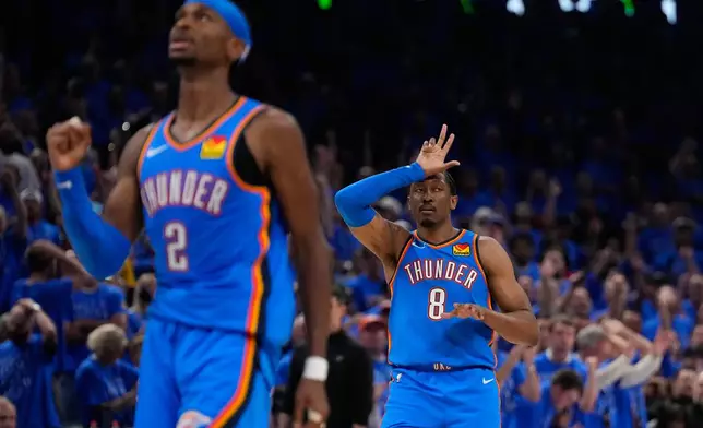 Oklahoma City Thunder guard Jalen Williams (8) and guard Shai Gilgeous-Alexander (2) celebrate after a 3-pointer during the second overtime of Game 1 in a third-round NBA basketball playoffs series against the San Antonio Spurs Monday, May 18, 2026, in Oklahoma City. (AP Photo/Tony Gutierrez)