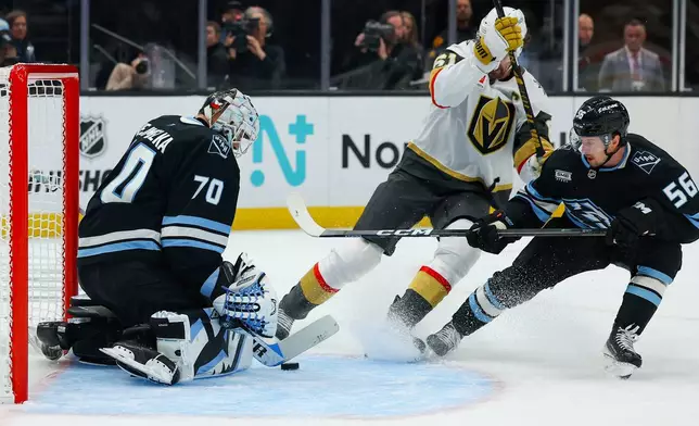 Utah Mammoth goaltender Karel Vejmelka (70) and right wing Kailer Yamamoto (56) blocks the puck against Vegas Golden Knights right wing Mark Stone (61) during the second period of Game 6 in the first round of an NHL hockey Stanley Cup playoff series, Friday, May 1, 2026, in Salt Lake City. (AP Photo/Melissa Majchrzak)