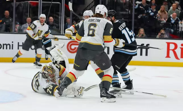 Vegas Golden Knights goalie Carter Hart (79) goes down during the first period of Game 6 in the first round of an NHL hockey Stanley Cup playoff series against the Utah Mammoth, Friday, May 1, 2026, in Salt Lake City. (AP Photo/Melissa Majchrzak)