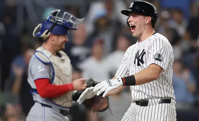 New York Yankees' Ben Rice reacts at home plate after hitting a two-run home run during the fifth inning of a baseball game against the Toronto Blue Jays, Tuesday, May 19, 2026, in New York. (AP Photo/Heather Khalifa)