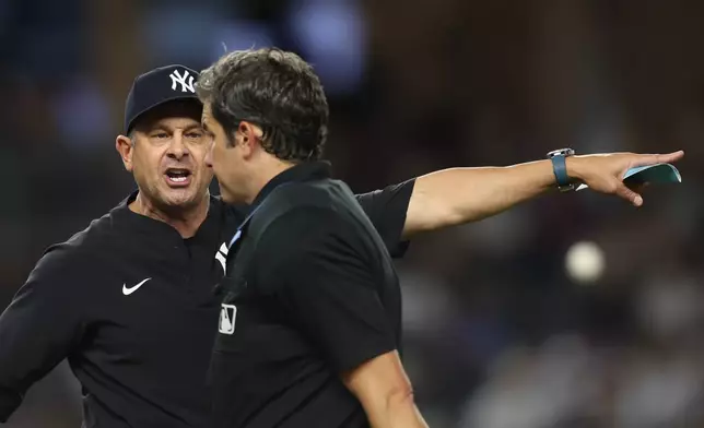 New York Yankees manager Aaron Boone, left, yells at the umpire and is ejected at the top of the eighth inning of a baseball game against the Toronto Blue Jays, Tuesday, May 19, 2026, in New York. (AP Photo/Heather Khalifa)