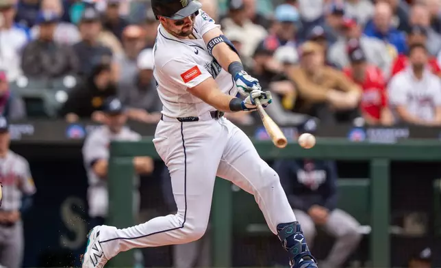 Seattle Mariners' Cal Raleigh hits into a double play to bat in a run during the third inning of a baseball game against the Atlanta Braves, Wednesday, May 6, 2026, in Seattle. (AP Photo/Stephen Brashear)