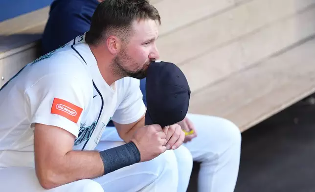 Seattle Mariners' Cal Raleigh sits in the dugout before a baseball game against the Atlanta Braves, Tuesday, May 5, 2026, in Seattle. (AP Photo/Lindsey Wasson)