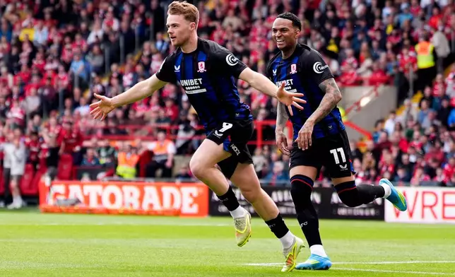 Middlesbrough's Tommy Conway, left, celebrates scoring the opening goal during the EFL Championship soccer match between Wrexham and Middlesbrough, in Wrexham, Wales, Saturday May 2, 2026. (Peter Byrne/PA via AP)
